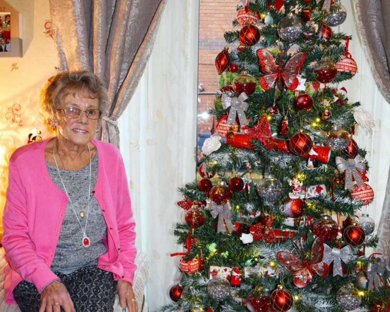 Sheila Wilkinson next to Christmas Tree
